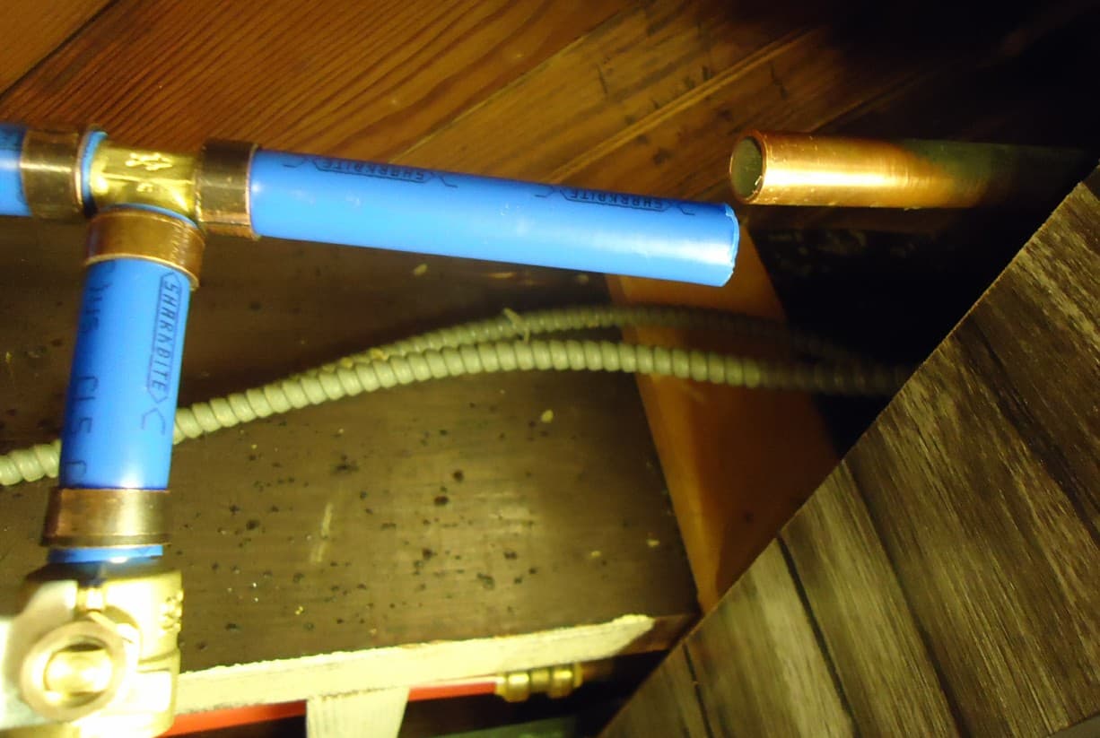 PEX pipes and valves in a basement ceiling